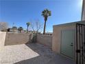 Fenced backyard with a gravel surface and access door at , Las Vegas, NV 89108