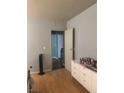 Bedroom with wood floors features a chest of drawers and view into hallway at , Las Vegas, NV 89108