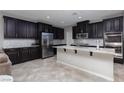 Contemporary kitchen featuring stainless steel appliances, a center island, and stylish backsplash at 1015 Solana Crest St, Henderson, NV 89052