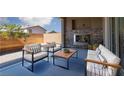 Inviting outdoor patio features a stone fireplace and comfortable seating, perfect for relaxation at 1015 Solana Crest St, Henderson, NV 89052