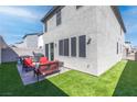Private backyard offers artificial grass, a paved patio, and ample space for entertaining at 10165 Canyon Mantle St, Las Vegas, NV 89166