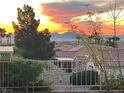 Mountain views from backyard behind wrought iron fence at sunset at 10717 Grand Cypress Ave, Las Vegas, NV 89134