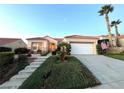 Beautiful single-story home featuring lush landscaping, a red tile roof, and a two-car garage at 10717 Grand Cypress Ave, Las Vegas, NV 89134