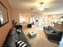 Spacious living room with neutral walls, carpet, ceiling fan and comfortable seating arrangement at 10717 Grand Cypress Ave, Las Vegas, NV 89134