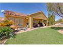 An inviting backyard featuring manicured lawn and covered patio great for outdoor enjoyment at 1074 Wagon Trl, Mesquite, NV 89034