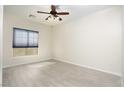 Bright bedroom features modern ceiling fan, window with blinds, and wood-look flooring at 1074 Wagon Trl, Mesquite, NV 89034