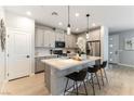 Modern kitchen featuring stainless steel appliances, a large island with bar seating, and stylish pendant lighting at 11561 Cedar Shore Ave, Las Vegas, NV 89138