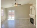 Inviting living room featuring a decorative fireplace, tile flooring, and sliding glass doors to the backyard at 1907 Thunder Storm Ave, North Las Vegas, NV 89032