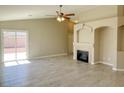 Open-concept living room showcasing a cozy fireplace, tile floors, and access to the outdoor patio at 1907 Thunder Storm Ave, North Las Vegas, NV 89032