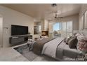 Spacious main bedroom with a modern fireplace, large windows, and plush king bed at 2104 Inverness Dr, Henderson, NV 89074