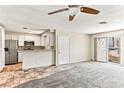 Open-concept living room with tile entry and carpet flooring next to the white cabinet kitchen area at 2232 Aspen Mirror Way # 103, Laughlin, NV 89029