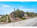 Single story home with brick paved driveway, desert landscaping, and a privacy wall at 2243 Albury Ave, North Las Vegas, NV 89086