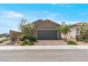 Charming single story home features a brick paved driveway and desert landscaping at 2243 Albury Ave, North Las Vegas, NV 89086
