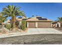 Charming home with a three car garage, desert landscaping, and solar panels at 263 Baring Cross St, Henderson, NV 89074