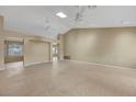 Spacious living room with high ceilings, neutral walls, tile floors, ceiling fans, and abundant natural light at 2920 Crown Ridge Dr, Las Vegas, NV 89134