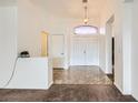 Bright foyer featuring elegant tile flooring, high ceilings, and a decorative light fixture at 306 Saint Augustine Ln, Henderson, NV 89014