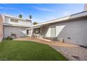 Spacious backyard with low-maintenance turf, brick patio, and an outdoor dining area, perfect for entertaining at 3323 Maclyon Way, Las Vegas, NV 89121