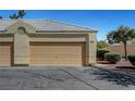 Single-car garage with a beige door, desert landscaping, and a well-maintained exterior at 364 Wild Plum Ln, Las Vegas, NV 89107