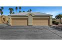 Two-car garage with beige doors and plenty of parking space in front of the property at 364 Wild Plum Ln, Las Vegas, NV 89107