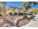 Well-maintained house with desert landscaping featuring native plants and decorative rock, offering curb appeal at 3663 Coventry Gardens Dr, Las Vegas, NV 89135