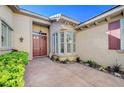 Welcoming home entrance featuring a double door with sidelights and landscaped garden, providing a warm, inviting feel at 3663 Coventry Gardens Dr, Las Vegas, NV 89135