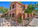 Inviting condo exterior featuring a ramp entrance, beautiful landscaping, and easy access at 3920 Legend Hills St # 202, Las Vegas, NV 89129
