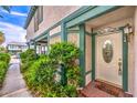 Welcoming front entrance with a decorative door, sidelights, and lush greenery at 4043 Chalfont Ct, Las Vegas, NV 89121