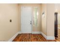 The entryway features hardwood floors, a white front door, and a slender window at 5046 Great Abaco St, North Las Vegas, NV 89031