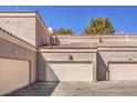 View of the garage of the condo with neutral paint and tiled roof at 5250 S Rainbow Blvd # 2046, Las Vegas, NV 89118