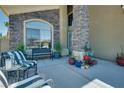 Welcoming front porch with comfortable seating and decorative plants at 5640 Coe Estates Ct, Las Vegas, NV 89149