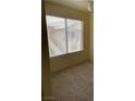 Bedroom with carpeted floors and a window offering natural light at 5710 E Tropicana Ave # 2033, Las Vegas, NV 89122