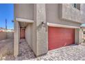 Side view of front entry with red garage door and paver driveway and walkway at 5734 Sunset Sedona St # Lot 10, North Las Vegas, NV 89081
