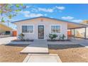 Well-maintained bungalow-style home with tidy landscaping and a covered carport at 6213 Burgundy Way, Las Vegas, NV 89107