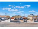 Inviting single-story home featuring a spacious driveway and modern concrete fencing at 6213 Burgundy Way, Las Vegas, NV 89107