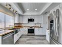 Modern kitchen featuring stainless steel appliances, white cabinets, butcher block countertops, and stylish lighting at 6357 Vicuna Dr, Las Vegas, NV 89146
