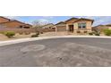 A tan single-story home with desert landscaping on a cul-de-sac at 665 Look Lively Ct, Henderson, NV 89011