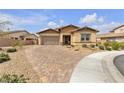 Inviting single-story home with desert landscaping and a brick driveway at 665 Look Lively Ct, Henderson, NV 89011