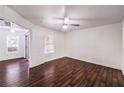 Spacious bedroom showcasing hardwood floors, a ceiling fan, and natural light, with an ensuite bathroom at 6800 E Lake Mead Blvd # 1047, Las Vegas, NV 89156
