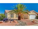Charming single-story home featuring a well-maintained yard, with desert landscaping and an attached two-car garage at 702 Carlitos Ave, North Las Vegas, NV 89031