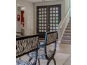 Bright foyer with modern staircase, beautiful doors and wood flooring at 7988 Pinnacle Peak Ave, Las Vegas, NV 89113