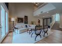 Bright living room with high ceilings, a modern staircase, and wood flooring at 7988 Pinnacle Peak Ave, Las Vegas, NV 89113