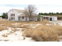 Quaint two-story home featuring carport, shed, and desert landscaping at 861 Mcmurray Dr, Pahrump, NV 89060