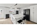 Modern kitchen featuring white cabinets, a spacious island, and black appliances at 861 Mcmurray Dr, Pahrump, NV 89060