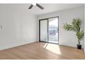 Sunlit bedroom featuring modern wood flooring and sliding glass doors to a balcony at 950 Seven Hills Dr # 2418, Henderson, NV 89052