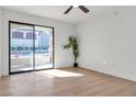 Bright bedroom with wood-look floors and sliding glass doors to a private balcony at 950 Seven Hills Dr # 2418, Henderson, NV 89052