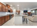 Open kitchen features granite countertops, stainless steel appliances, and island seating at 10216 Chrysolite Pl, Las Vegas, NV 89143