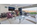 Bright living room with patio access, stylish furniture, and modern entertainment setup at 10216 Chrysolite Pl, Las Vegas, NV 89143