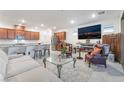 Bright, open living space featuring modern finishes, stainless steel appliances, and comfortable seating at 10216 Chrysolite Pl, Las Vegas, NV 89143