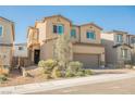 View of a two-story tan home with desert landscaping and a brick driveway at 10415 Andele Ave, Las Vegas, NV 89166