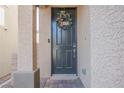 Close up of the front door with wreath and brick walkway at 10415 Andele Ave, Las Vegas, NV 89166